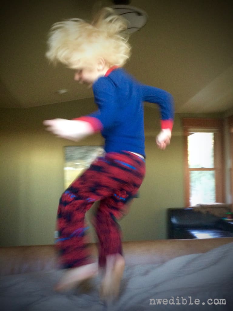 Boy jumping on bed